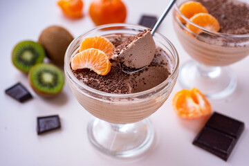 Chocolate panacota with grated chocolate for dessert. Vanilla panacota for breakfast. Close-up