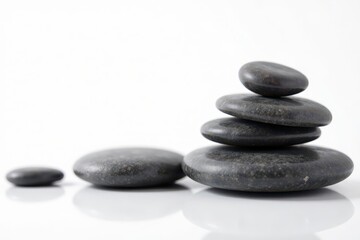 Various sized, polished spa stones, white backdrop , massage stones, white background, detail