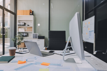 Entrepreneur Asian businessman and businesswoman discussing new business project in tablet in modern Meeting In Modern Office, Asian business casual concept.