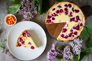 Berry pie on a gray background. A piece of cherry pie and cherry pie for dessert. View from above. Close-up