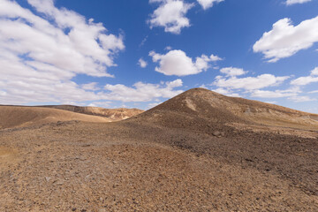 travel through the sandy desert, blue sky and many clouds