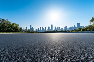 Empty asphalt road leading to city skyline