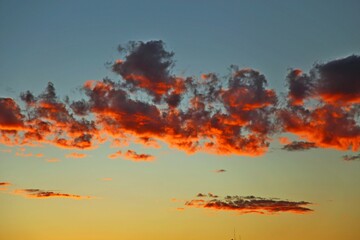 
Beautiful clouds in vibrant colors. Dawn with reddish clouds in the sky. Sun rising over the...