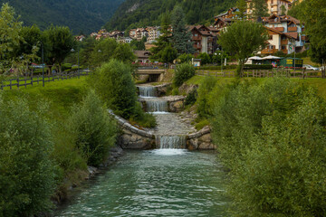 Obraz premium Beautiful traditional summer view in Molveno, Trentino Alto Adige, Italy, scenic village, lake, and mountain landscape