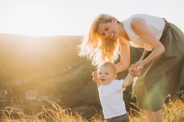 Joyful Mother and Baby Bonding Outdoors During a Beautiful Sunset in Nature