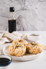 Spicy rice and beef donuts on a plate on the table vertical view