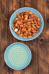 Heap of almond nuts and almond oil.