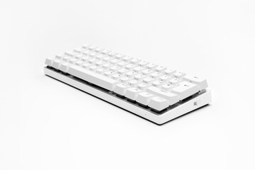 White, wireless gaming mechanical computer  keyboard closeup, isolated. Minimal, modern design on white background. side view.  60 percent keyboard. copy space. Communication device.