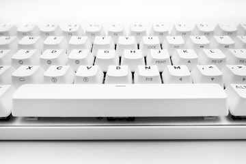 White, wireless gaming mechanical computer  keyboard. Closeup on the space bar key, keycap. Minimal, modern design on white background. Cyberspace. copy space. Data and communication. Macro key