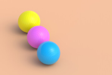 Row of colorful fitness balls on beige background. Pilates training. Sports equipment. Bodybuilding accessory. Copy space. 3d render