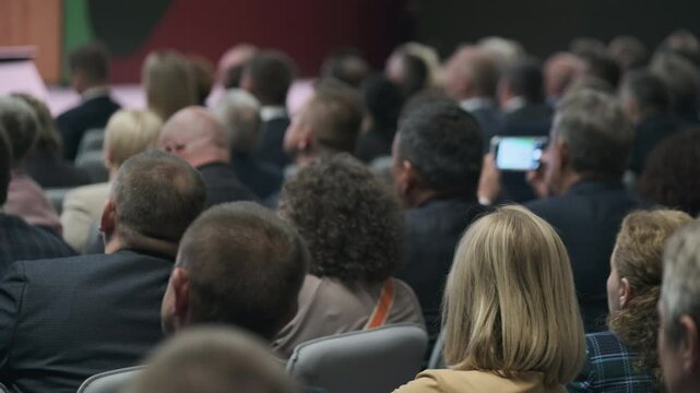 Large audience seated in rows attending a professional conference or seminar indoors at venue