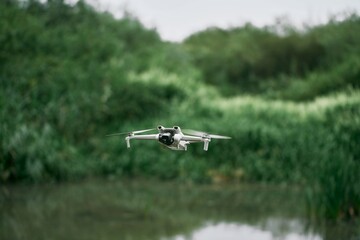 Drone hovering over green forest