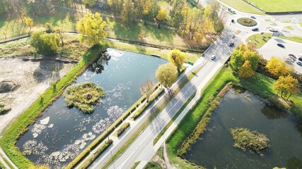 Aerial view of urban pond and road in autumn