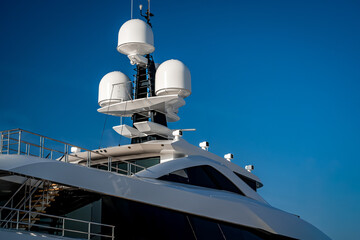 Close up view of the radar navigation system and communication mast on a white modern super mega...
