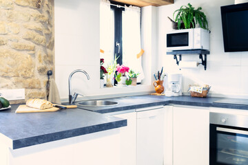 Modern rustic kitchen with fresh bread on countertop.