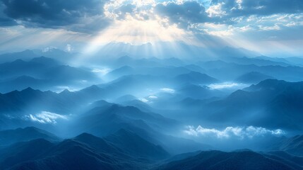 Sunbeams pierce through misty mountain range.