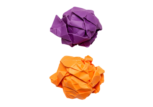 Colorful crumpled paper balls in purple and orange on a black background showcasing recycling and creativity in art