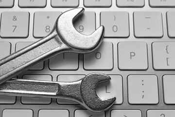 Technical support concept. Wrenches on keyboard, top view