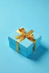 Obraz premium A light blue gift box tied with a golden ribbon, perfect for celebrations
