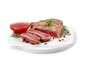 Pieces of delicious beef meat, spices and sauce isolated on white