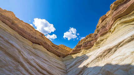 Fototapeta premium Majestic canyon with steep walls and vibrant rock colors under blue sky