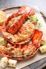 Delicious lobster tails with microgreens and green onion on table, above view