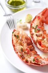 Delicious lobster tails with green onion on white table, closeup