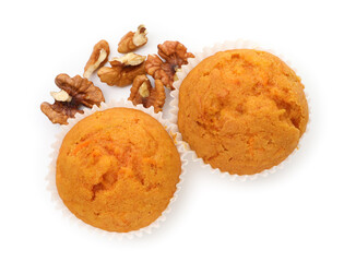 Tasty sweet carrot muffins and walnuts isolated on white, top view
