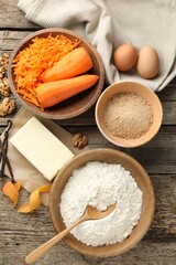 Different ingredients for making carrot cake on wooden table, flat lay