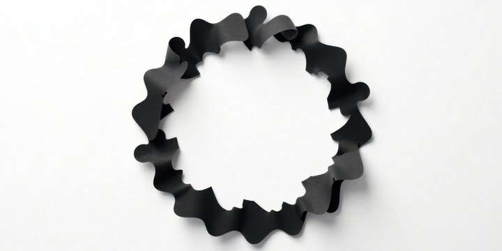 An abstract circular frame crafted from dark paper, featuring a wavy, organic design, ideal for showcasing text or imagery within its central void.