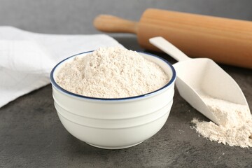 Brown rice flour on grey table, closeup