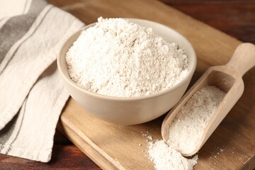 Brown rice flour on wooden table, closeup