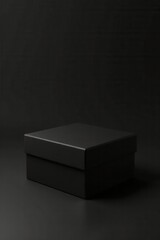 A Single Mysterious Black Box on a Dark Surface, Ideal for Product Presentation or Packaging Design