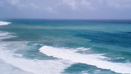 Aerial view of powerful high waves crashing in the Indian Ocean during a cyclone in Mauritius, capturing the intensity of the storm