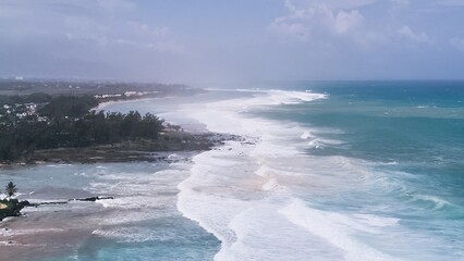 Aerial view of powerful high waves crashing in the Indian Ocean during a cyclone in Mauritius, capturing the intensity of the storm