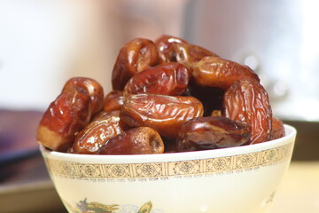 A close-up of brown dates in a bowl