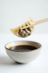 Close-up photo of a dumpling picked up by chopsticks