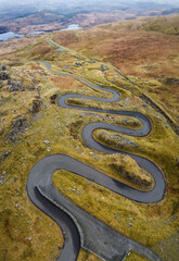 Aerial view of narrow winding road in mountainous area 