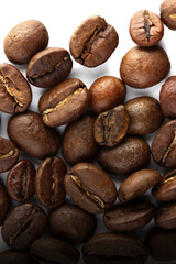 Color photo. Textured background. Coffee beans scattered on white background. Wallpaper. Cover. Postcard. Advertisement