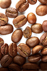 Color photo. Textured background. Coffee beans scattered on white background. Wallpaper. Cover....