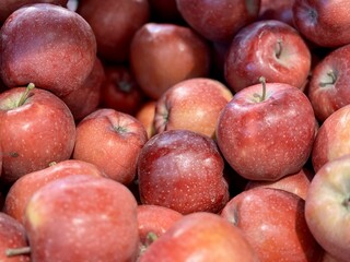 Box filled with fresh natural bio organic red apples placed on counter in local food market