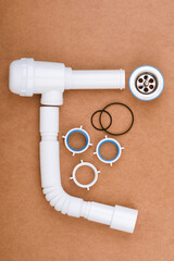 Complete kit for assembling a sink drain with flexible tube and accessories.