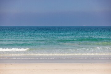 A pristine beach with turquoise waters and golden sand in the UAE