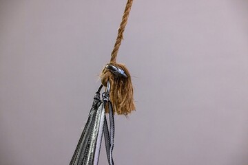 Strong rope knot connection with metal clip in detailed close up with white background