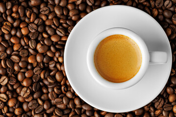 Top view white espresso cup with saucer stands on roasted beans, highlighting rich crema and creating perfect background for coffee lovers