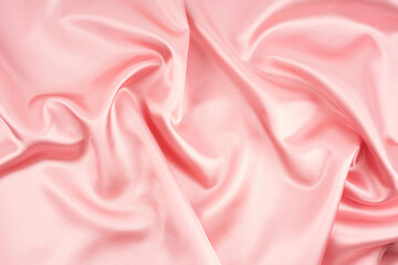 Luxury background design. Smooth texture of pink silk.