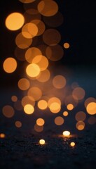 Soft focus glittering golden bokeh spots overlaying dark backdrop, blur, shimmering, elegant