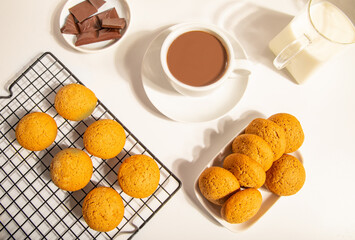 Hot chocolate or coffee espresso with chocolate pieces and cookies.