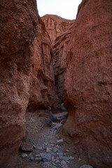 Narrow path inside the canyon, hiking trail, surrounded by red sandstone rocks