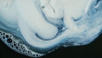 Fototapeta premium abstract fluid swirl of white and blue liquid with foamy bubbles on dark background, perfect for artistic background and texture